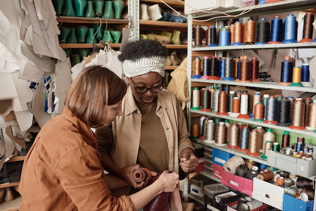 Women choosing threads for sewing together