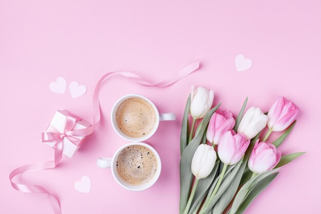 women day 8 march concept morning coffee gift box and beautiful spring tulip flowers on pink paste