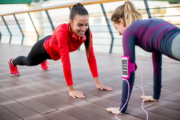 Women doing plank on riverside