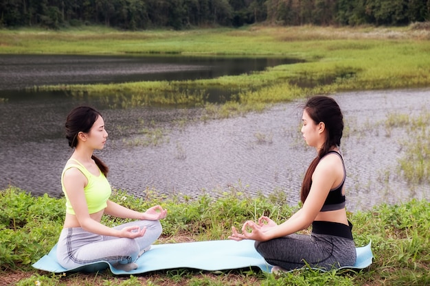women doing yoga in the nature