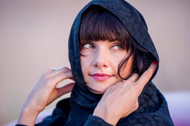 Women dressed middle eastern way poses on sunset background.