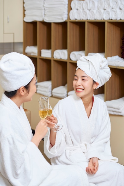 Women drinking champagne in spa centre