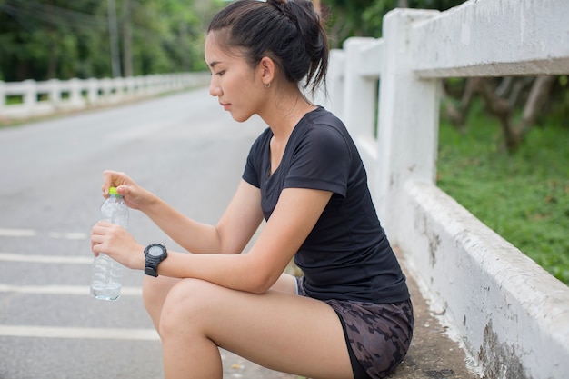 Women drinking water after running