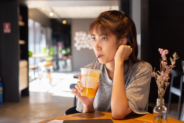 Women drinking water in coffee cafe.