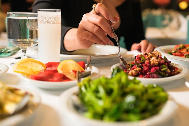 Women eating traditonal mezze. turkish cuisine with raki and mezze. raki and mezze. dinner table