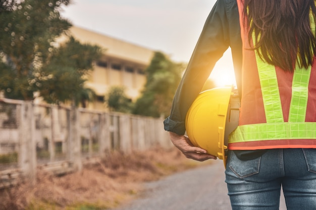 Women Engineer holding helmet hard hat factory industrial businesses