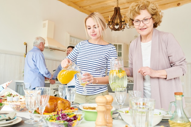 Women of Family Setting Dinner Table