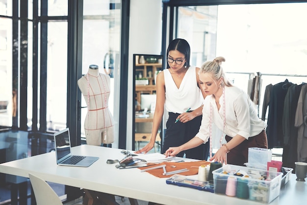women fashion and designers with garment at workshop for material design or teamwork at office young female person or tailors working together on clothing line for style size or production