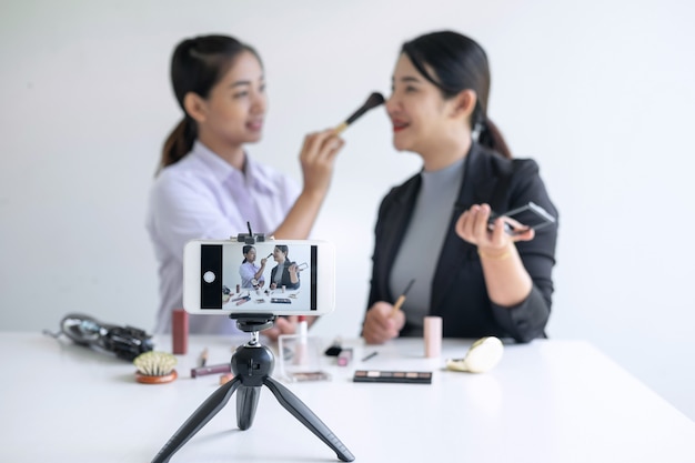 Women filming a makeup tutorial