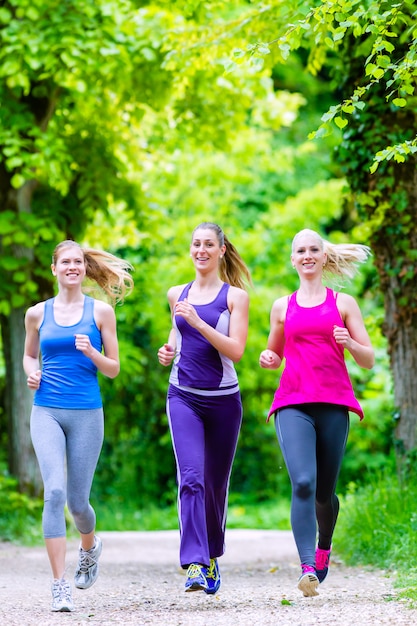 Women in forest running for sport