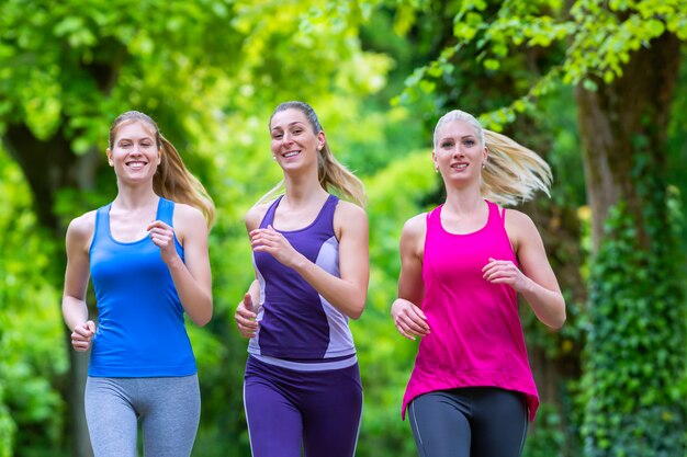 Women in forest running for sport