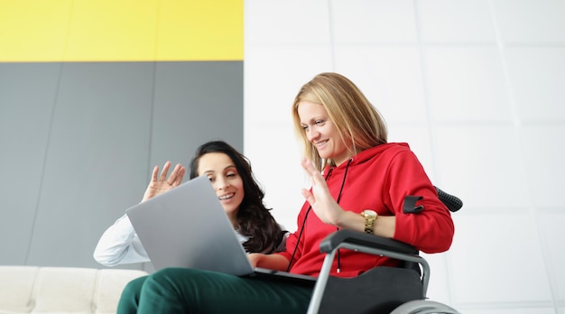 Women greeting family via online video call using laptop woman visit friend in wheelchair