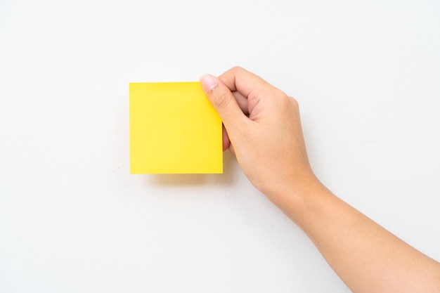 Women hand hold yellow adhesive note