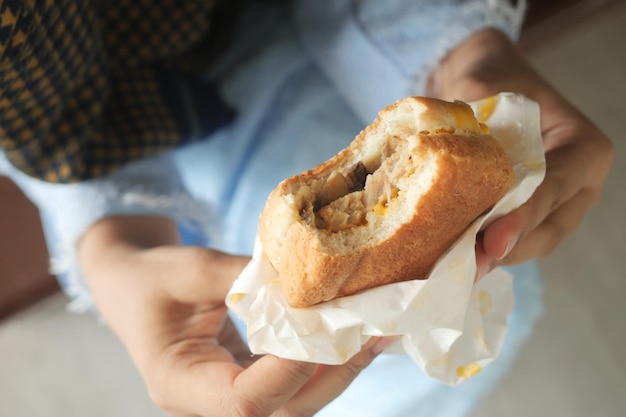 Women hand holding beef burger top view