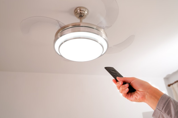 Women hand is controlling the lamp and fan