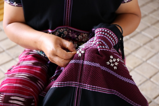 Women hand sewing, Thailand