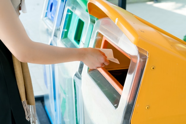 Women hand throwing away garbage to the bin or trash