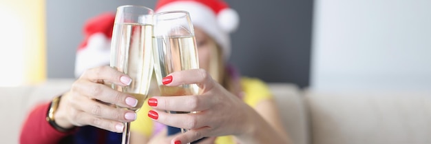 Photo women hold champagne drinks glass filled with alcohol raise toast for new year coming