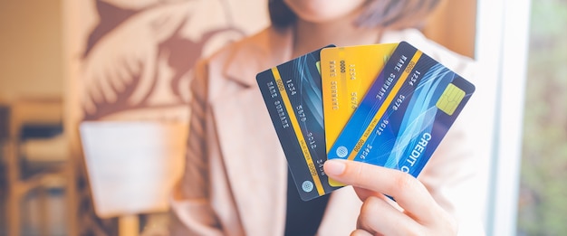 Women hold three credit cards.ards.For web banner.