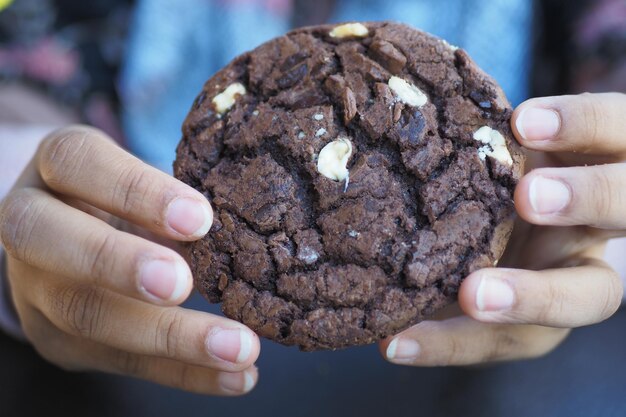 Women holding a chocolate cookies