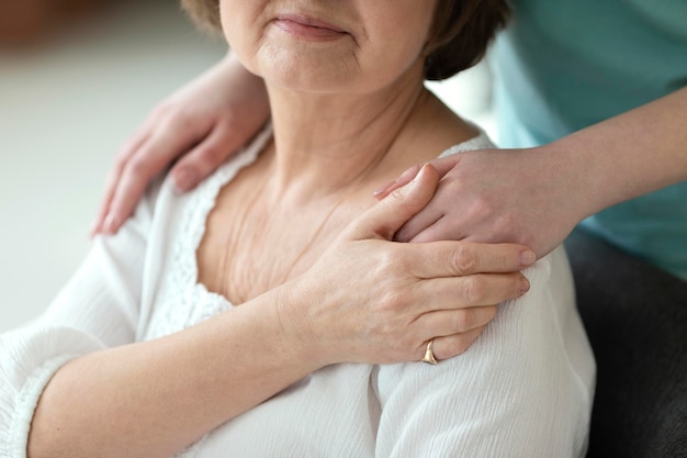 Women holding hands close up