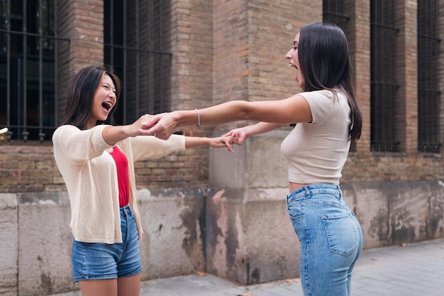 Women holding hands full of joy during their date