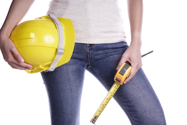 Women holding helmet and Measuring Tape in hand. Craftsman tool