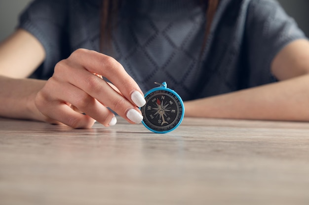 a women holds a compass in hand