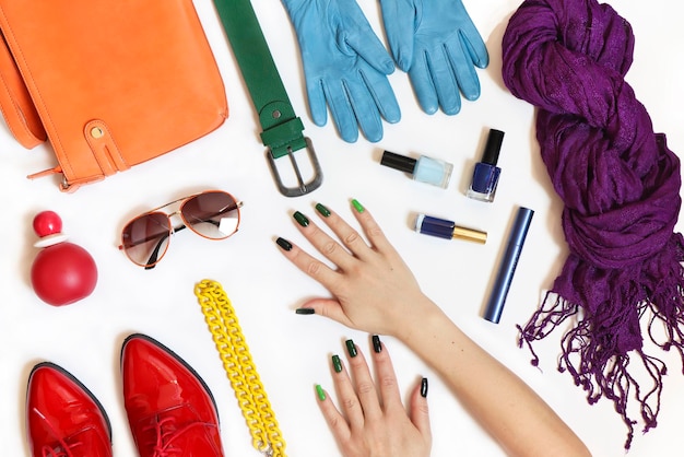 Women is hands with different accessories on a white background