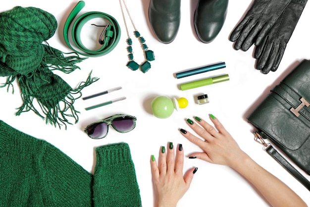 Women is hands with manicure and green accessories