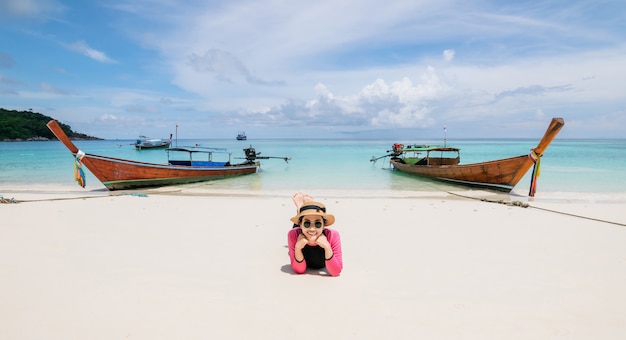 Women lie on the beach and the sea have a holiday summer relaxing