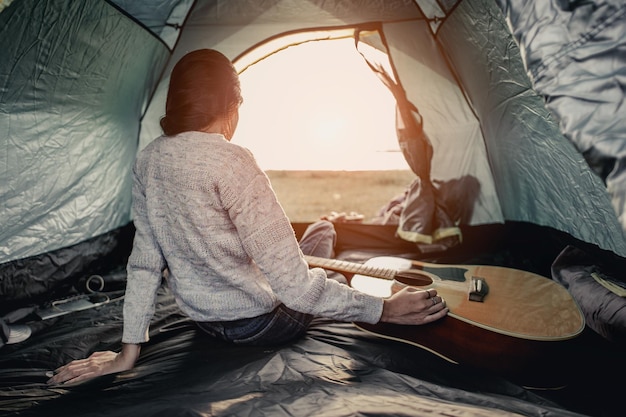 Women lie in tents.at camp.