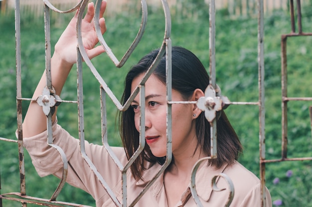 Women look out And standing holding steel mesh