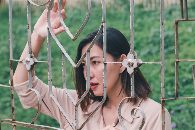 Women look out And standing holding steel mesh