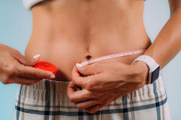 Women Measuring Her Waist Size