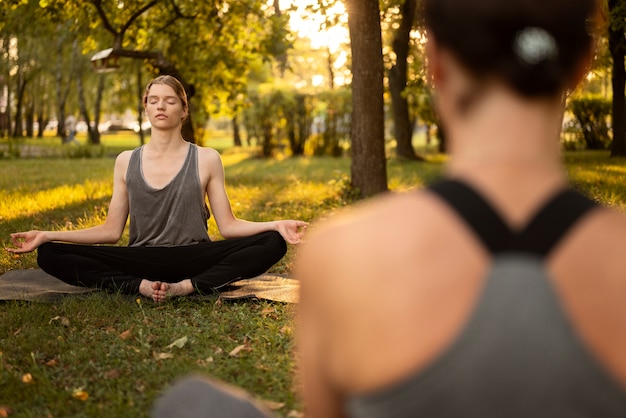 Women meditating together in nature