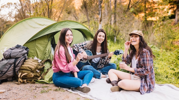 Women near tent looking at camera