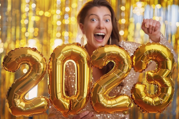 Women at new year party with gold balloons