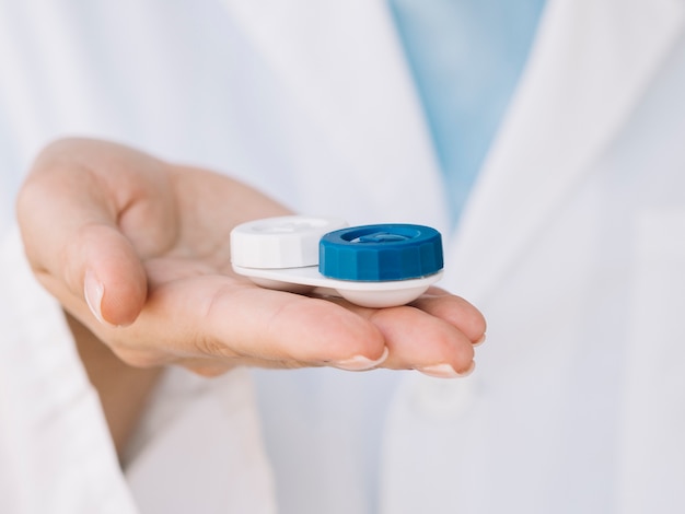 Women ophthalmologist holding a pair of contact lenses