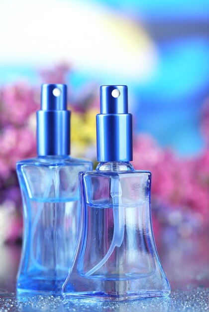 Women perfume in beautiful bottles and flowers