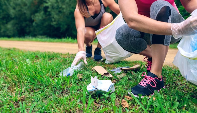 Women picking up trash doing plogging