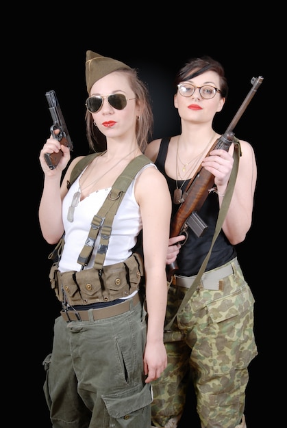 женщины позируют в военной форме и оружии