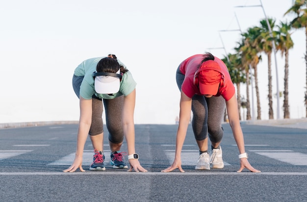 Women prepared to run away on a road