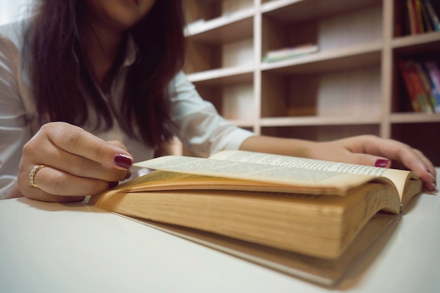 women reading book and relaxing in her living room.selective focus