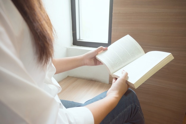 Women reading book and relaxing in library. selective focus