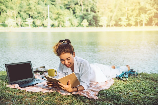 Women reading next to the river