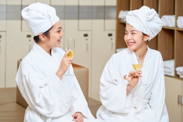 Women relaxing with champagne in spa salon