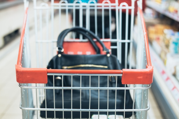 Women's bag in the trolley in a supermarket