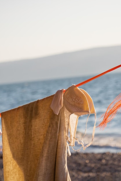 women's clothes drying on a rope on the galilee sea background