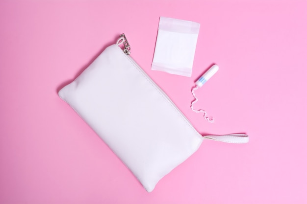 Women's daily panty liner and tampon on pink